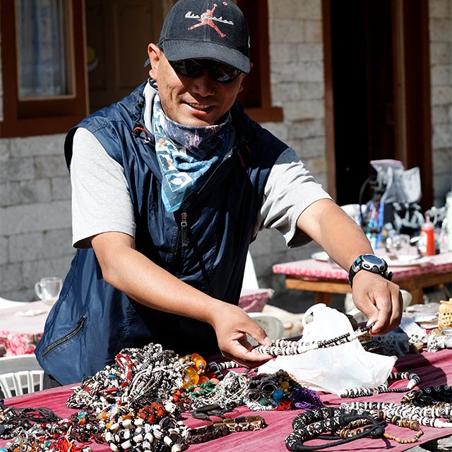 Da'Ongchu helps lay out jewelry